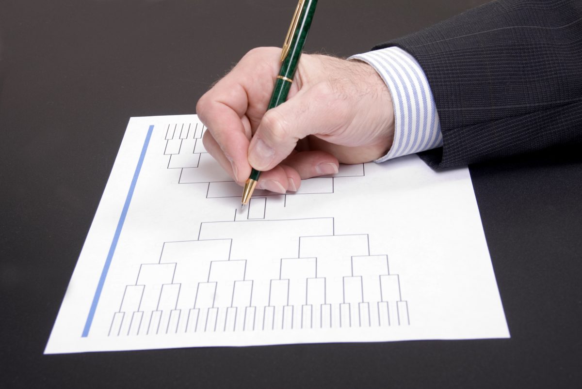 March Madness Businessman Hand Filling In Brackets